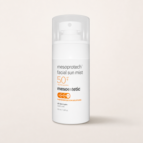 Mesoestetic Mesoprotech Facial Sun Mist SPF 50+ on a warm cream studio background