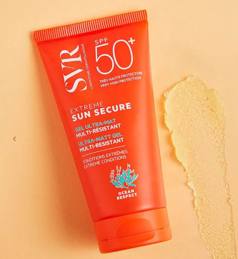 Orange sunscreen tube with SPF 50+ on a beige background